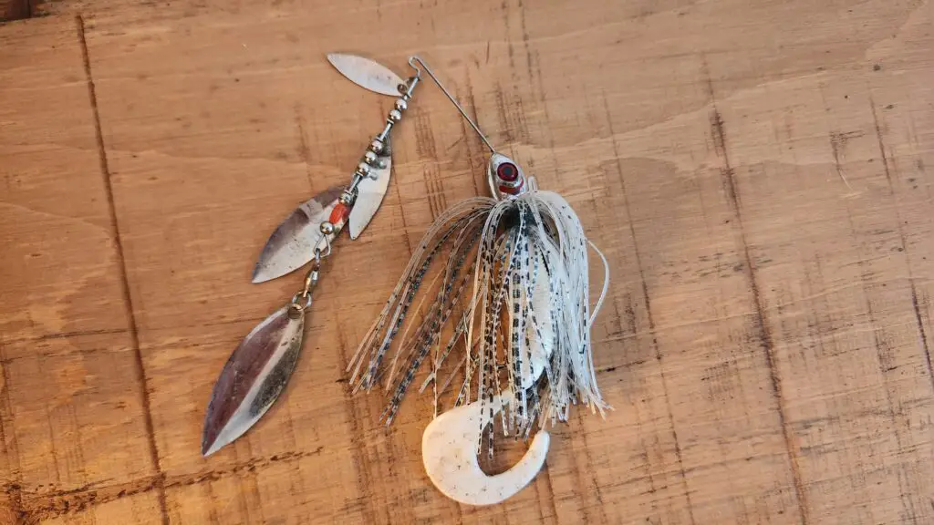 Spinnerbait lure with 4 willow leaf spoons. Black and white skirt with one-tail worm leader.